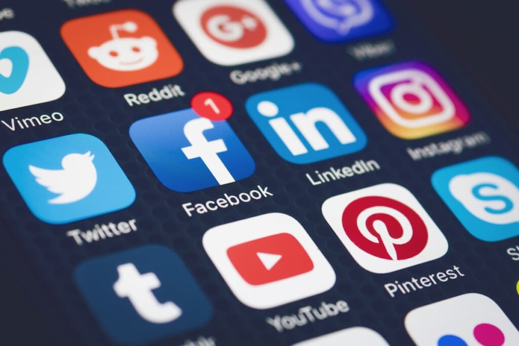 An image of a smartphone's main screen displaying apps, including icons for Twitter, Facebook, and LinkedIn, while the other apps are blurred.